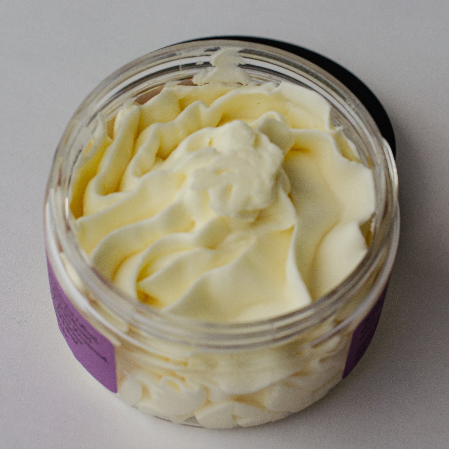 Whipped Tallow Balm jar with lid off to show light and airy texture